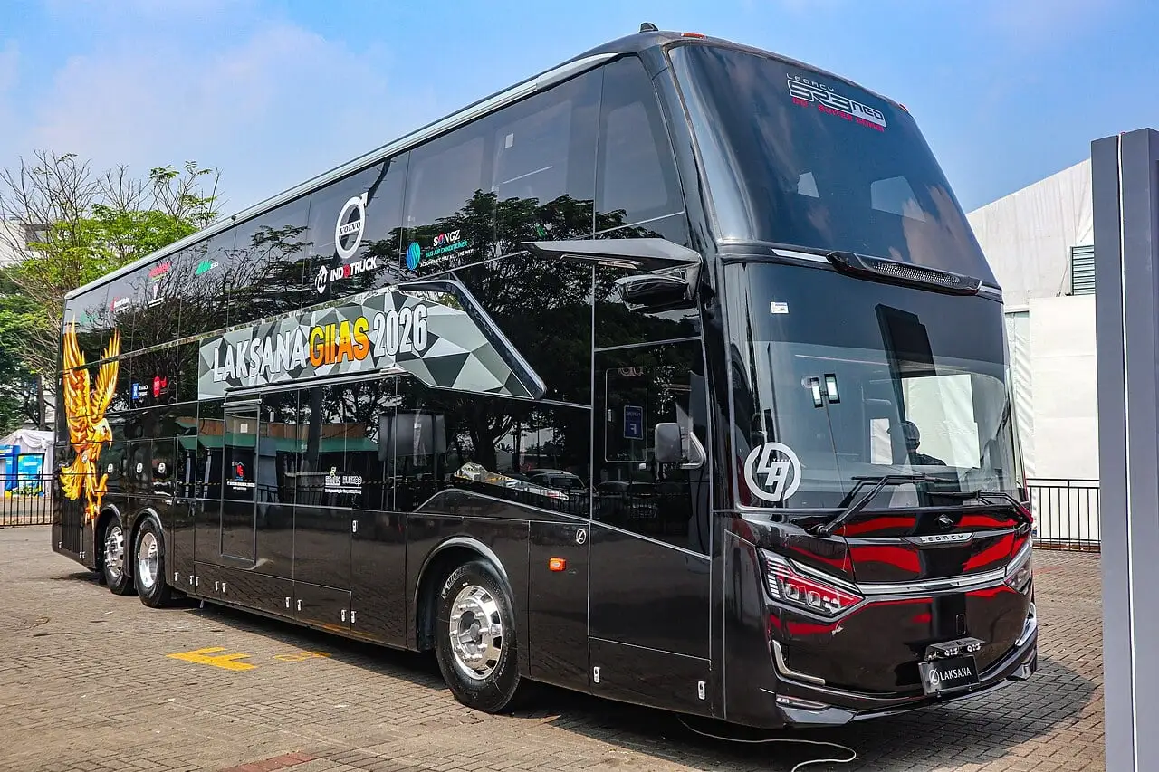 A black double-decker "suites" sleeper coach with private sleeping cabins, pictured at a motor show in Indonesia